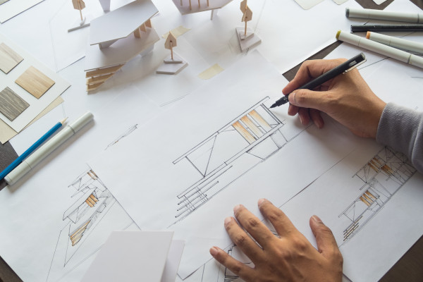 A man drawing a building