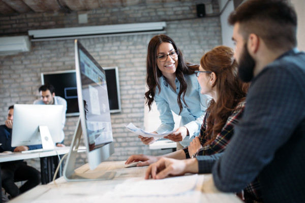 Three people having a discussion in an office