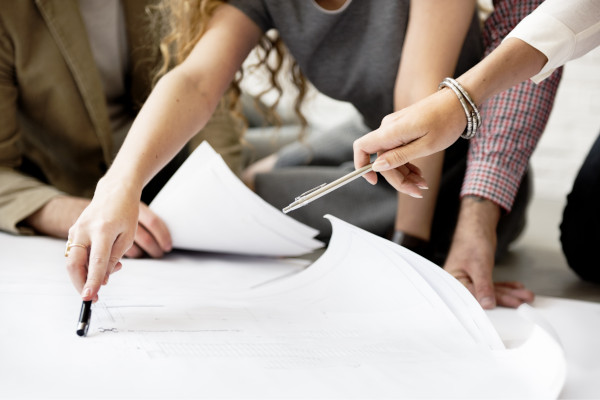 People discussing a floor plan